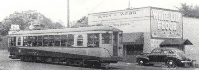 1gb. Black &amp; Webb store with Streetcar at East Spring Street, 1946